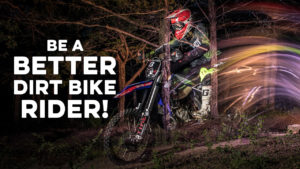 Shutter drag picture of a dirt bike rider in the woods.