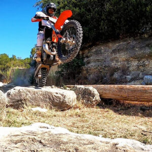 dirt bike wheelie on rocks