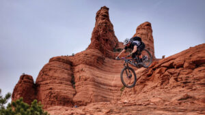Mountain biker riding their bike down a steep rock