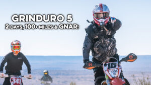 dirt biker pointing at the camera.