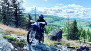 rider on a dirt bike riding up an uphill climb