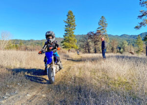 A family riding dirt bikes together.