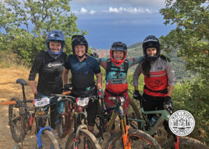 Mountain bike enduro racers all smiles on the trail.