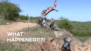 Hard Enduro Racer launching his dirt bike at the top of a hill climb.