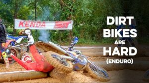 A hard enduro racer laying on his back after crashing in an endurocross section.