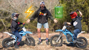 A dad and his kids on there Torrot electric kids motorcycles
