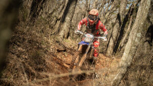 Dirt bike racer riding in the woods