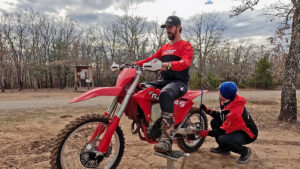 Dirt bike coach and rider setting sag before a ride.