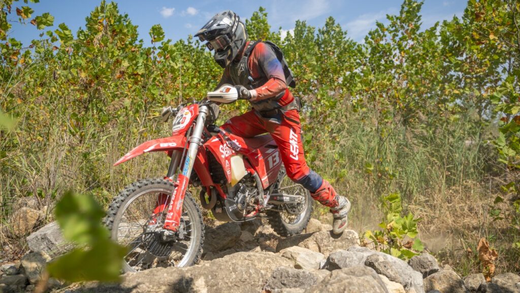 Brian Pierce navigating a rocky section on his red GASGAS dirt bike at the 2025 Leadbelt Enduro under a clear sky.