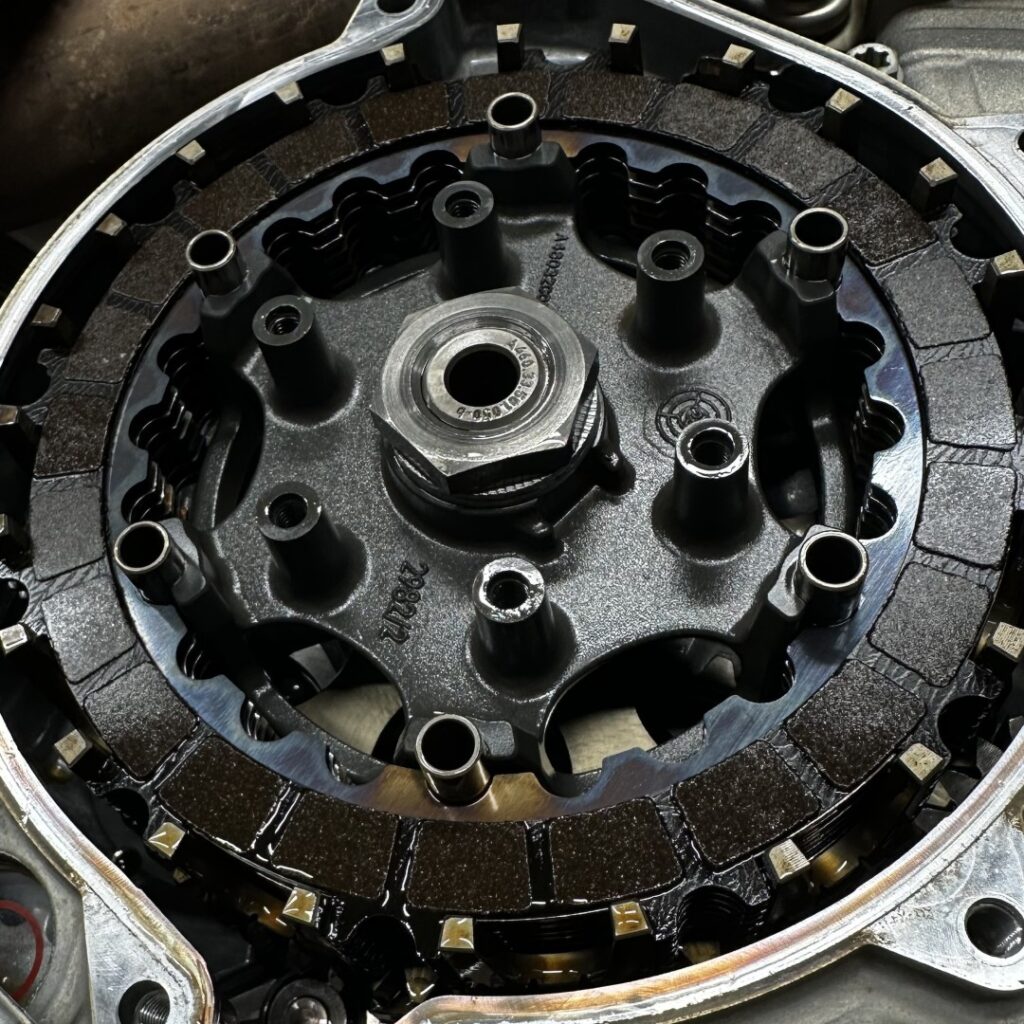 Close-up of burned clutch plates inside a GASGAS dirt bike engine before the 2025 Leadbelt Enduro.