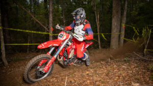 Dirt bike racer attacking the trail during an enduro race.