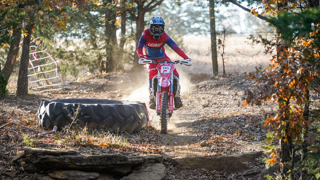 Enduro racer using body position to avoid a trail obstacle.