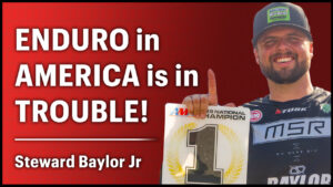 Enduro racer holding number one plate before talking about enduro in America.