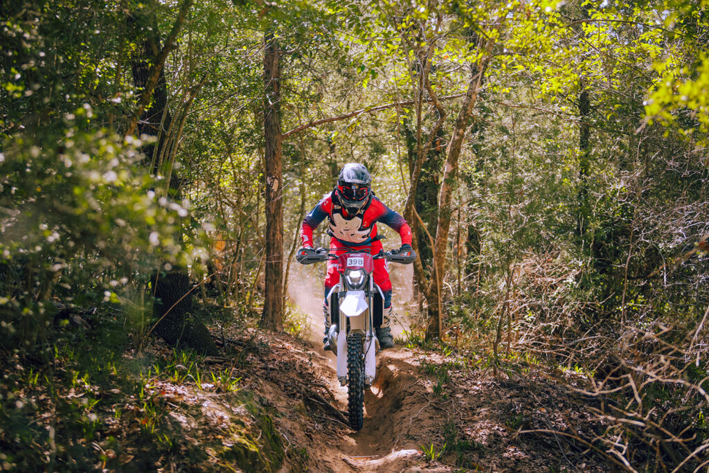 Fantic XE300 enduro bike riding tight singletrack at Sandwinder Enduro