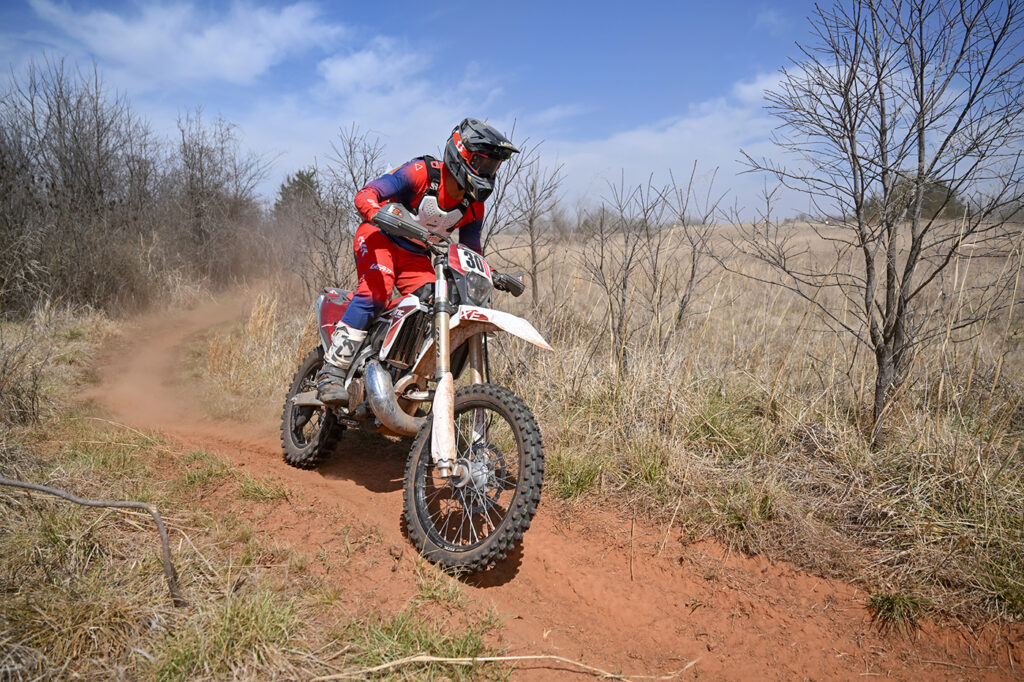 A well balanced dirt biker racing an enduro on a Fantic XE300 two stroke.