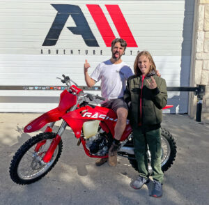 Dirt bikers excited to pick up their new dirt bike.