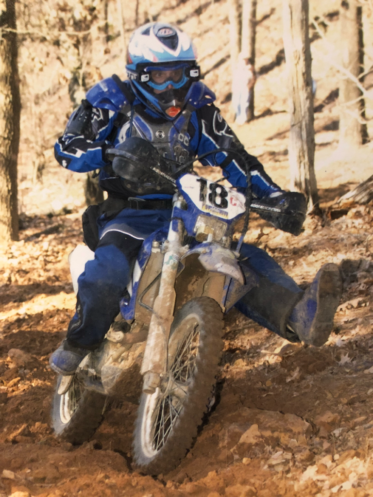 Dirt bike racer showcasing poor style and over the boot riding pants.