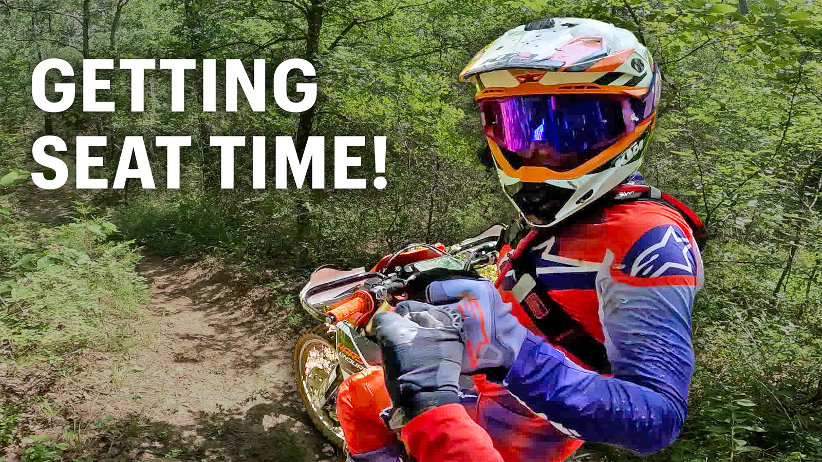 Dirt bike riders getting seat time on Texas singletrack, fist bumping during a two‑stroke throttle therapy session.